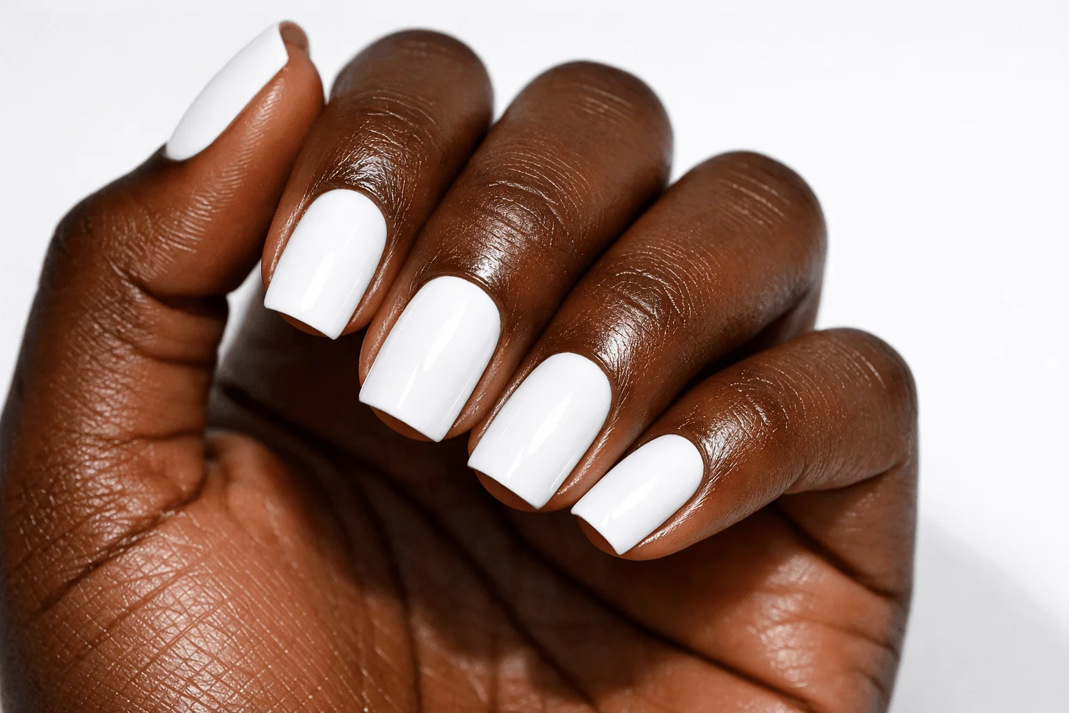 21 Best White Nail Polish Picks for Every Skin Tone 4 Bright white nail polish on deep skin tone