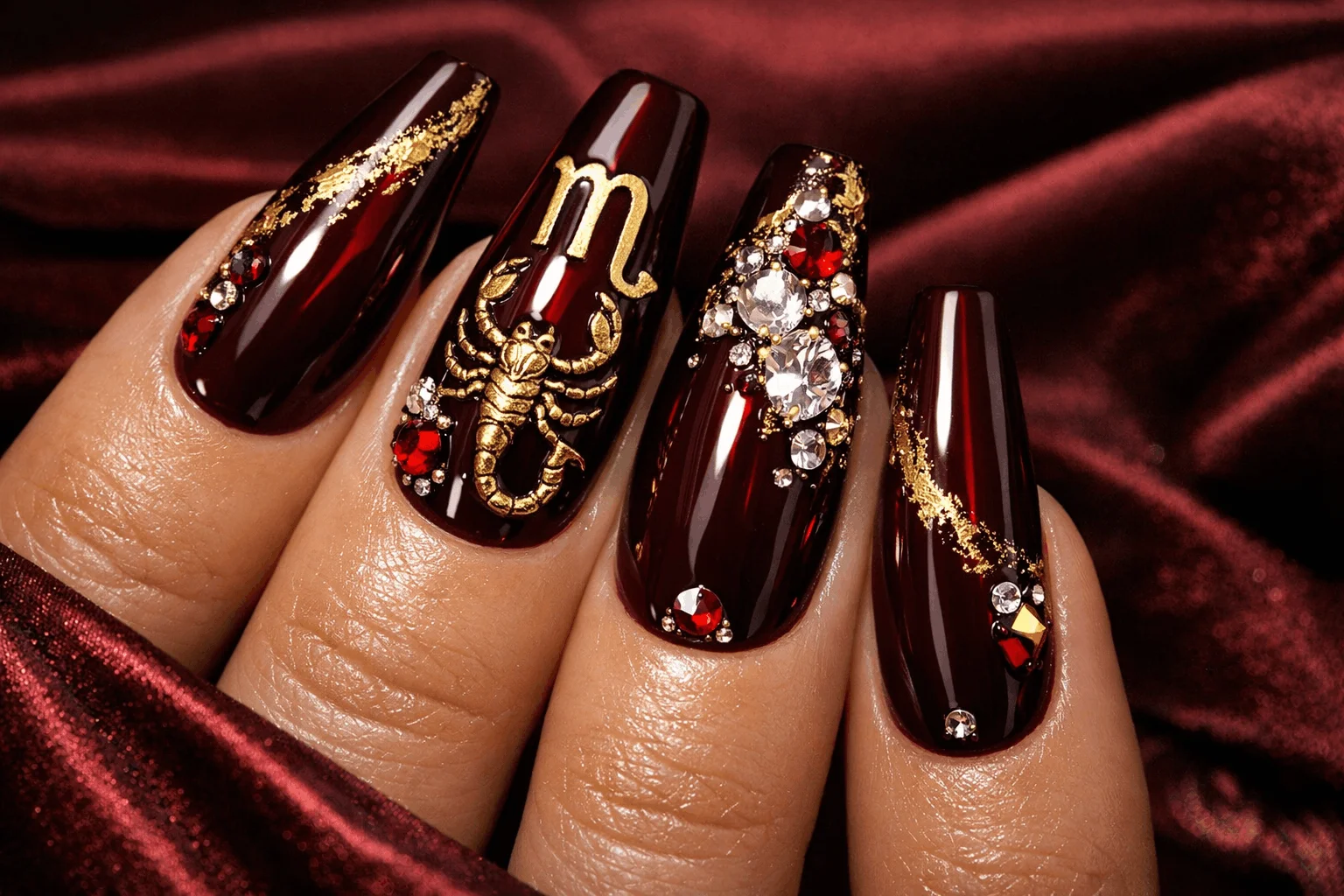 21 Scorpio Nails Designs for Mysterious Vibes 4 Burgundy scorpio themed nails with gold foil glam manicure