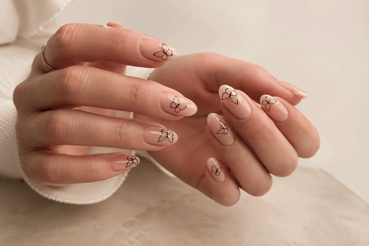 10 Butterfly Nails Designs You’ll Want This Season 4 Minimalist nude butterfly nail design with simple outline