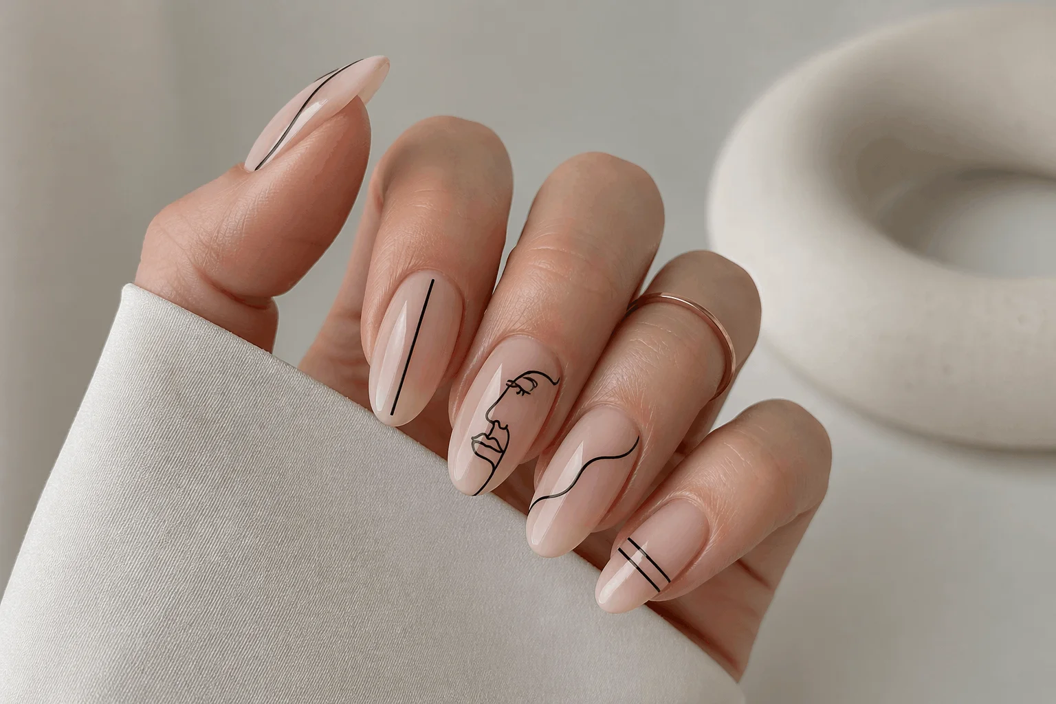 10 September Acrylic Nails That Look Stunning 8 Neutral acrylic nails with minimalist black line art, clean aesthetic design, soft lighting,