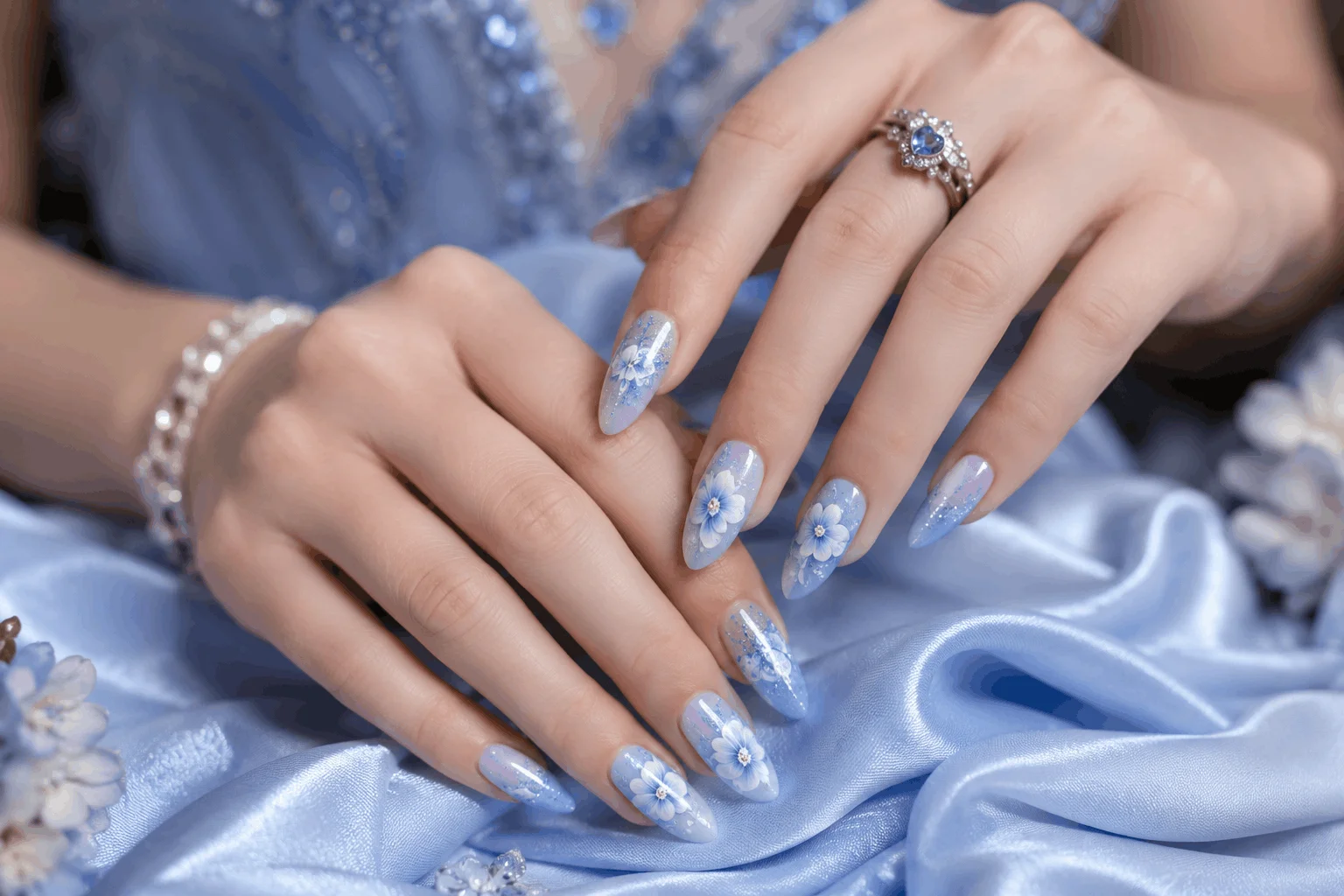 10 Blue Prom Nails That Will Steal the Spotlight Tonight 10 Elegant blue almond prom nails with floral accents