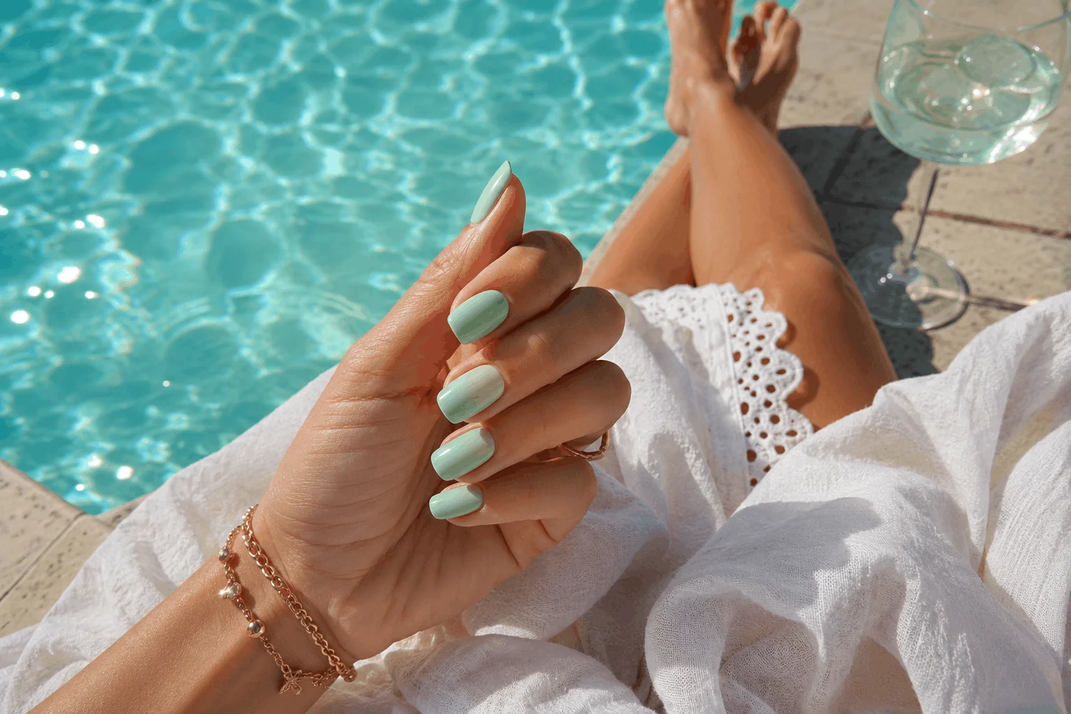 12 Green Summer Nails That Scream Vacation Vibes 8 Fresh mint green nails beside swimming pool in summer