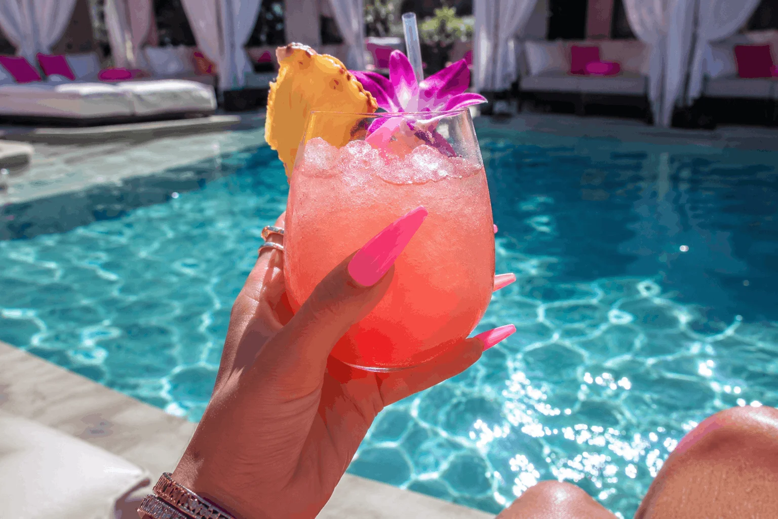 12 Hot Pink Summer Nails That Scream Vacation 3 Neon pink summer nails beside luxury pool