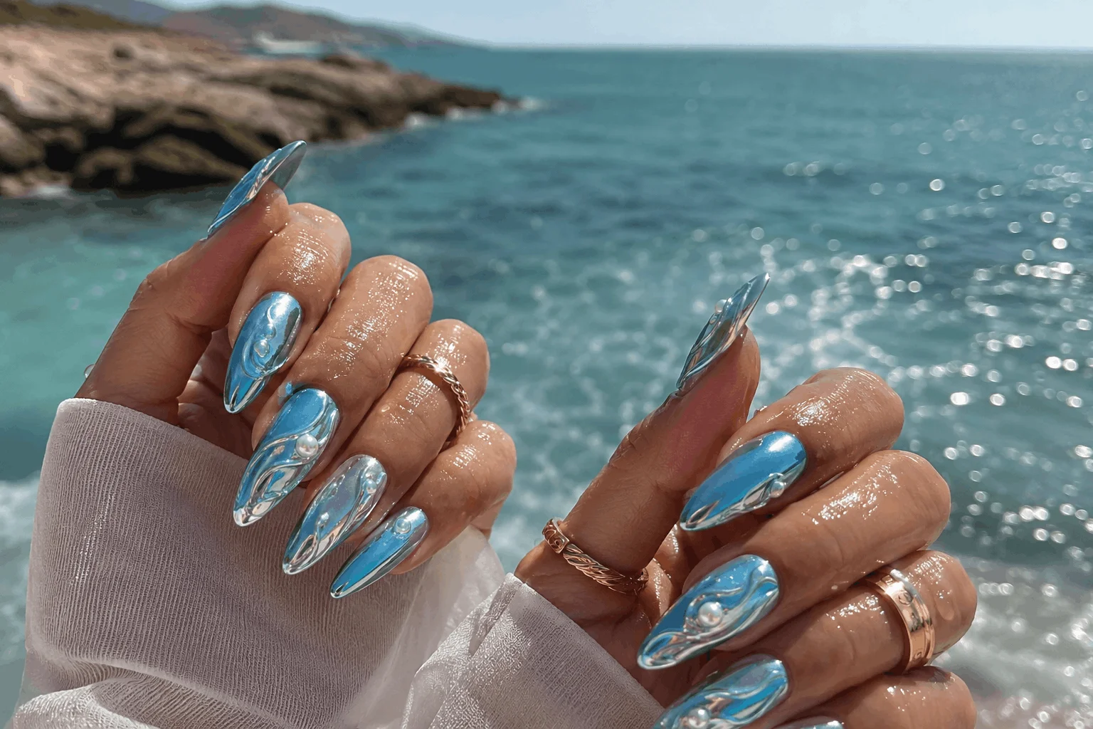 10 Vacation Nails Summer Lovers Are Obsessed With 3 Ocean blue chrome nails inspired by tropical beach water
