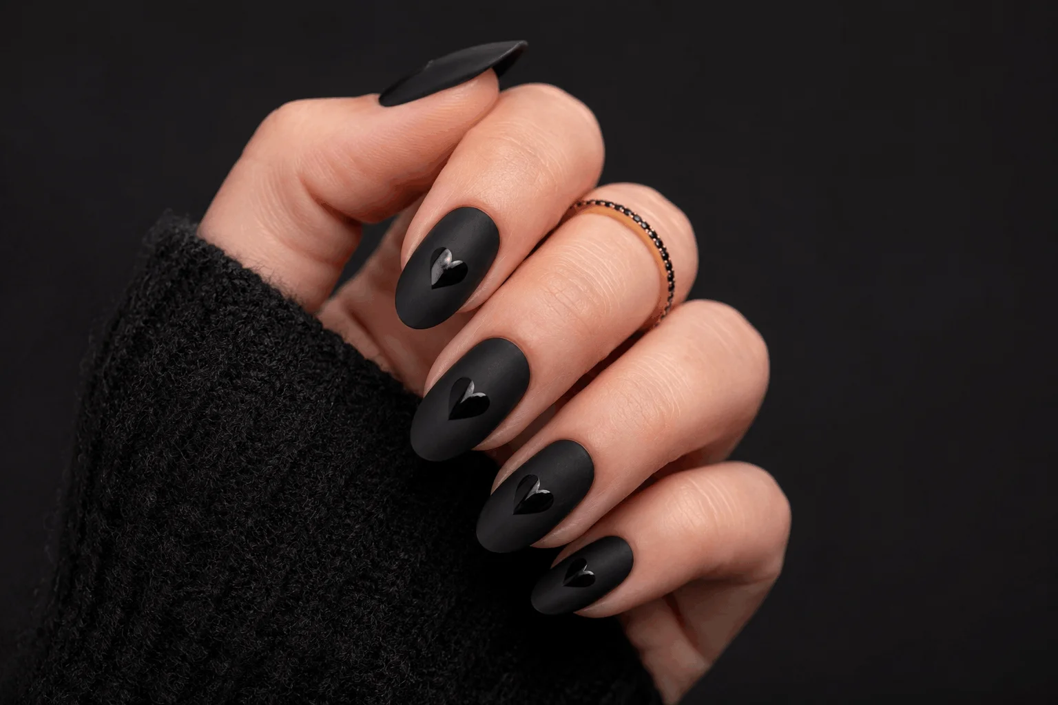 11 Dark Valentines Nails That Are Bold & Romantic 7 Matte black Valentine's nails with glossy heart accents